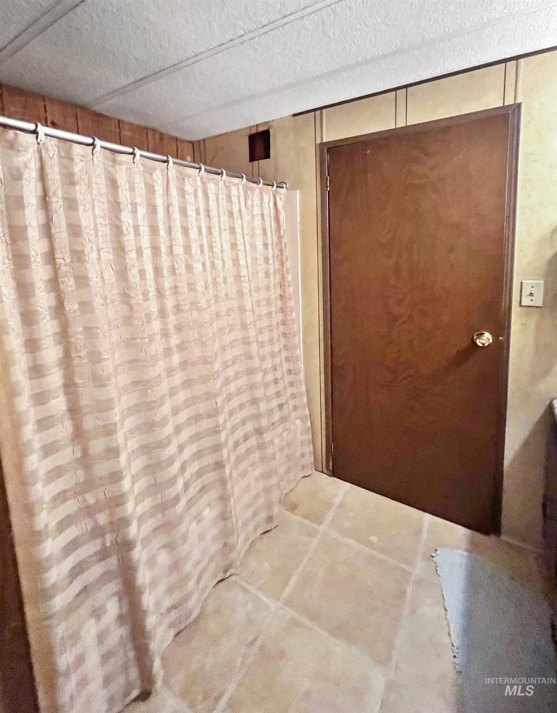 955 South Main Street, Unit 30 Cascade, ID 83611 - Photo 13 of 19 Bathroom with a textured ceiling and a shower with shower curtain