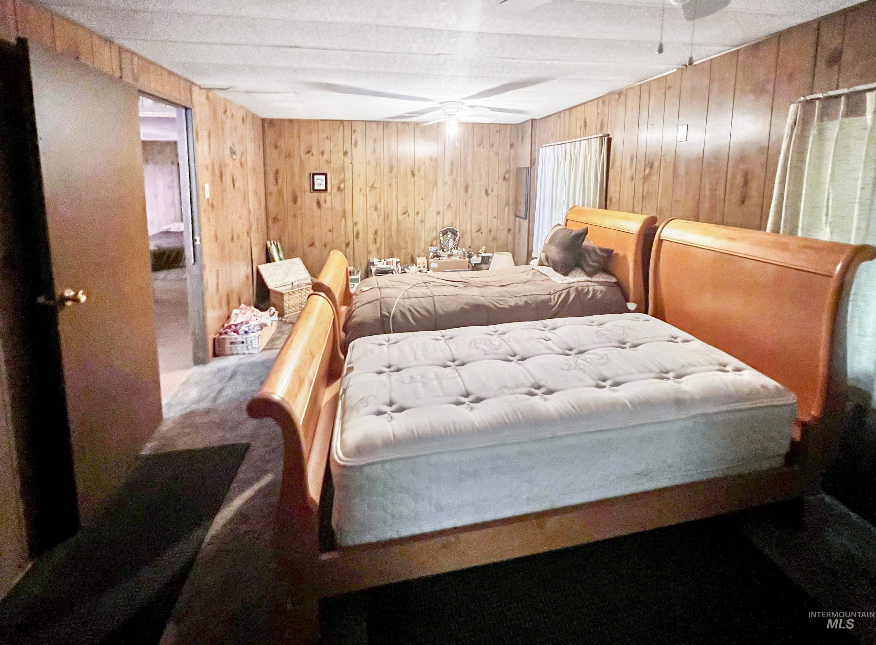 955 South Main Street, Unit 30 Cascade, ID 83611 - Photo 14 of 19 Bedroom with wooden walls and carpet flooring