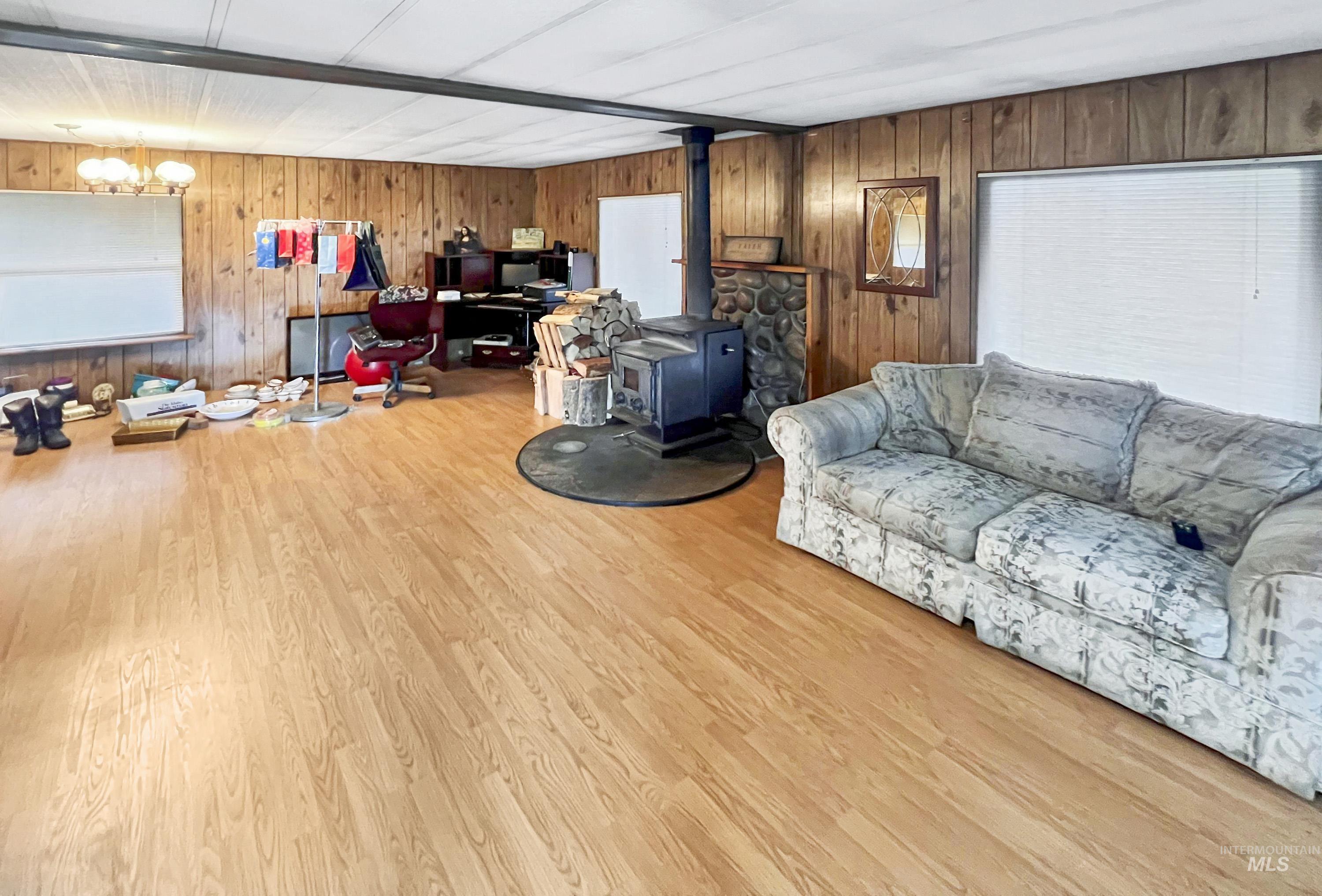 955 South Main Street, Unit 30 Cascade, ID 83611 - Photo 7 of 19 Living area featuring a wood stove, wood walls, and wood finished floors