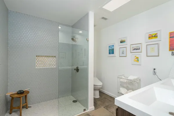 a room with furniture a rug and a fan