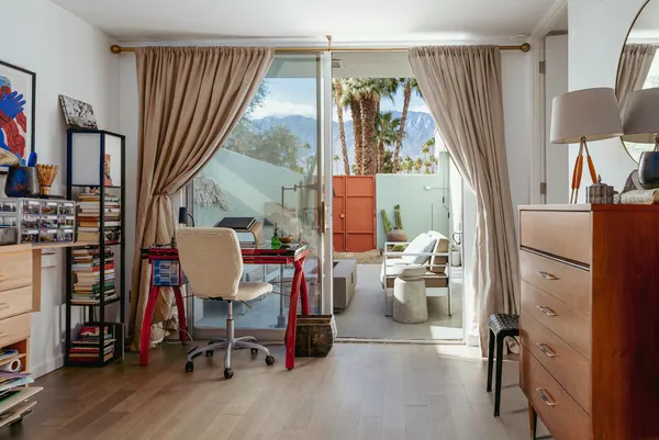 a front view of a house with a yard and a garden