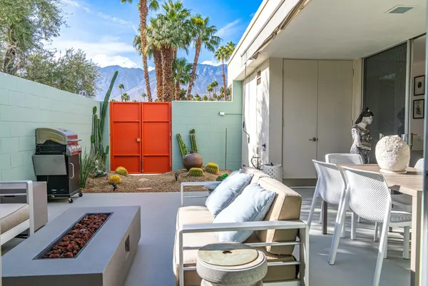 a view of a house with a backyard porch and sitting area