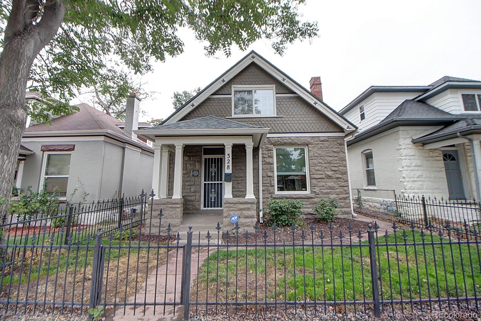 328 Inca Street Denver, CO 80223 - Photo 1 of 35 a front view of a house with a garden