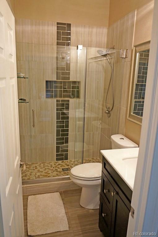 328 Inca Street Denver, CO 80223 - Photo 15 of 35 a bathroom with a granite countertop sink toilet and shower