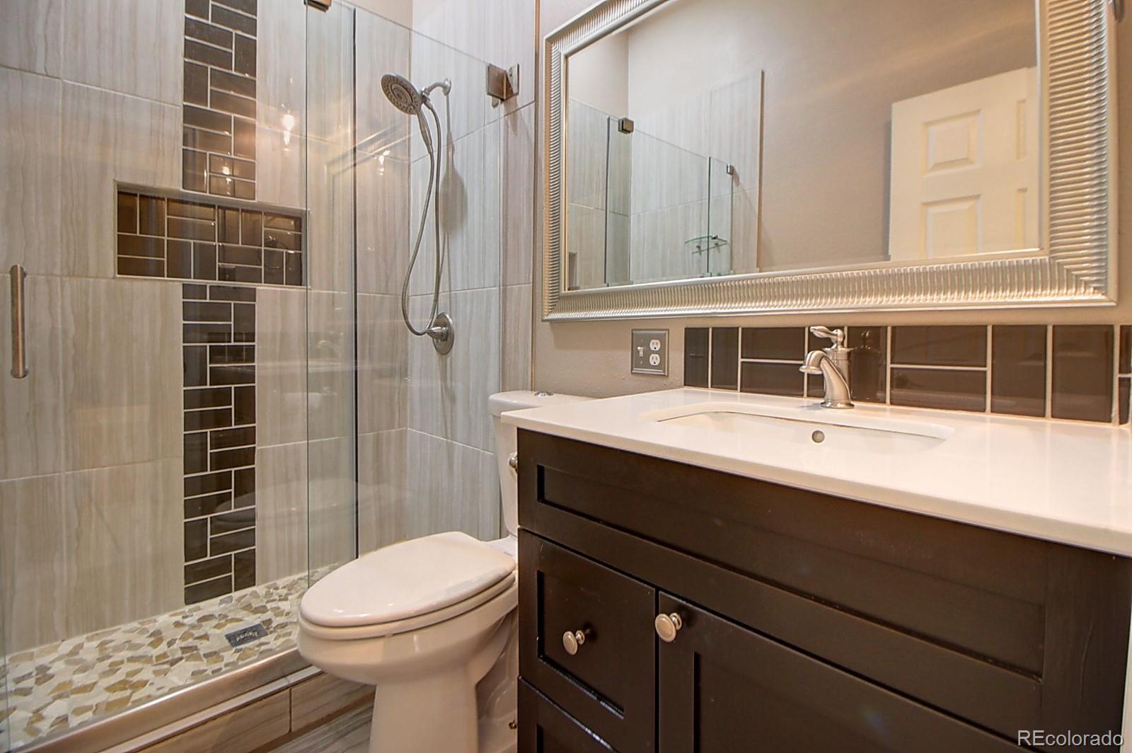 328 Inca Street Denver, CO 80223 - Photo 16 of 35 a bathroom with a sink a toilet and shower