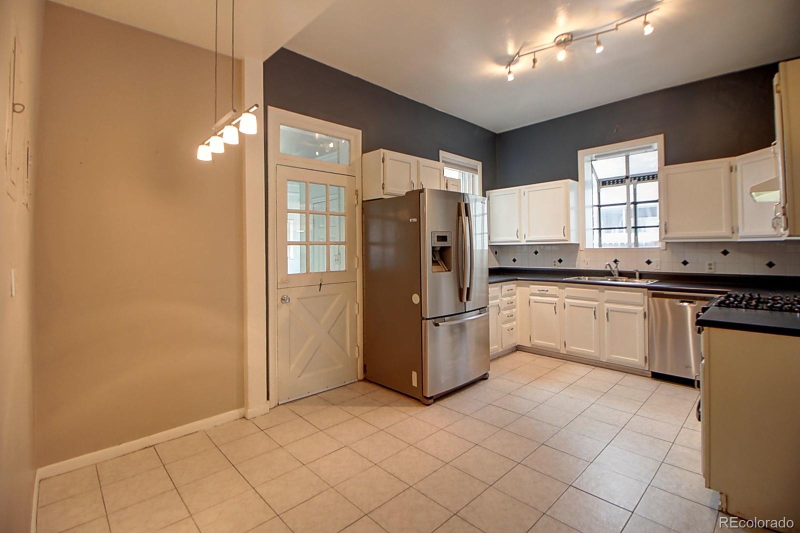 328 Inca Street Denver, CO 80223 - Photo 17 of 35 a kitchen with a refrigerator sink and cabinets