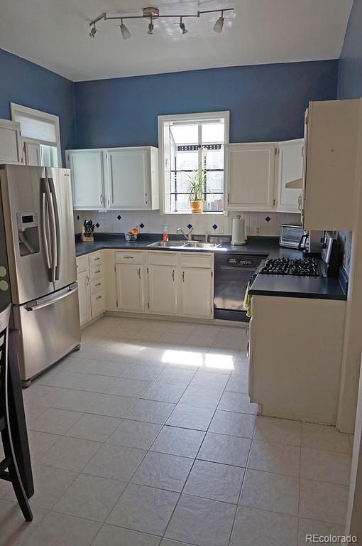 328 Inca Street Denver, CO 80223 - Photo 20 of 35 a kitchen with a sink a counter top space cabinets and stainless steel appliances