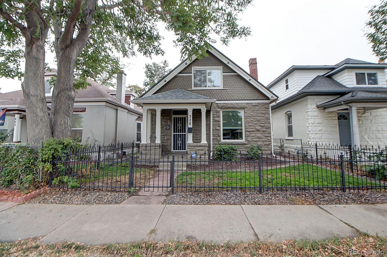 328 Inca Street Denver, CO 80223 - Photo 2 of 35 a front view of a house with a garden and plants