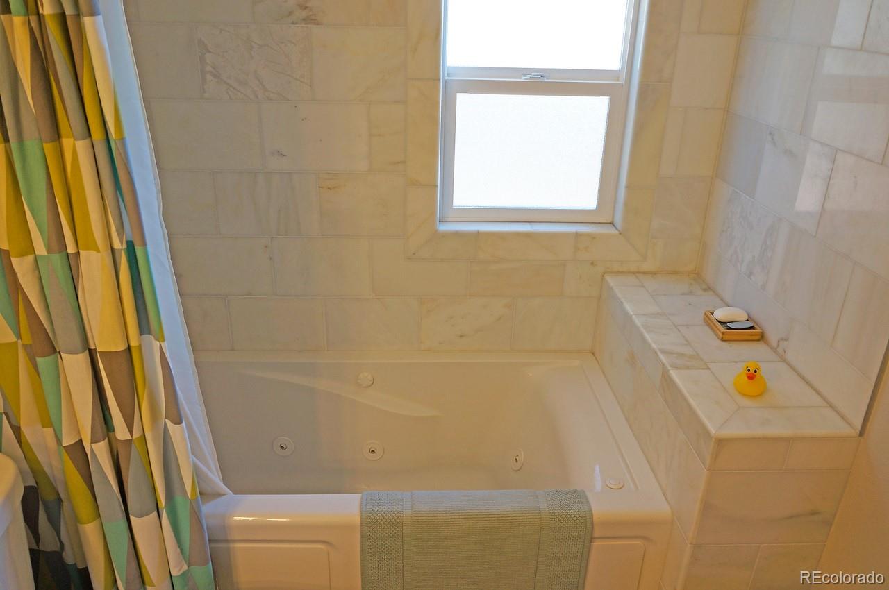 328 Inca Street Denver, CO 80223 - Photo 32 of 35 a bathroom with a bathtub
