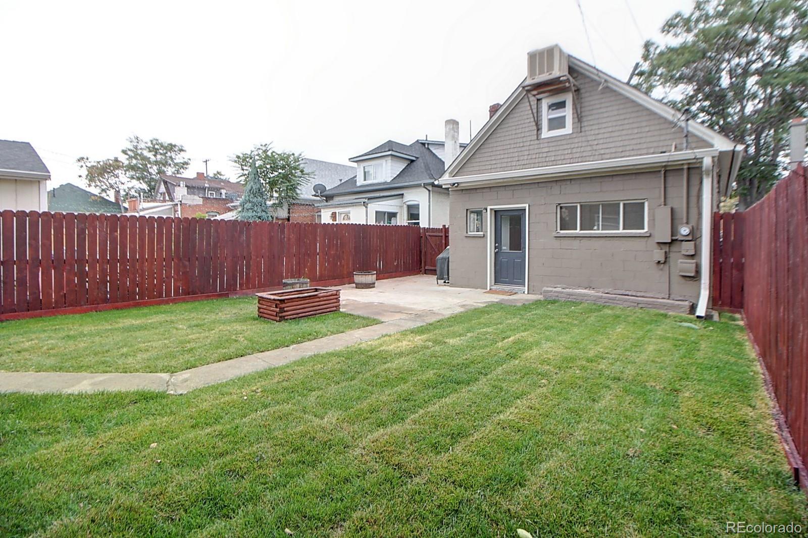 328 Inca Street Denver, CO 80223 - Photo 35 of 35 a view of a house with a yard and a garden