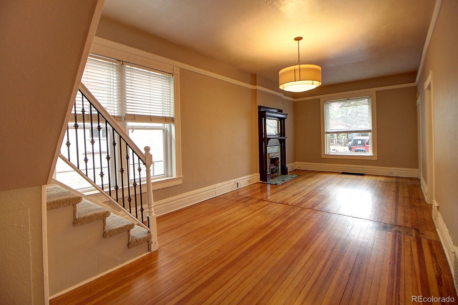 328 Inca Street Denver, CO 80223 - Photo 6 of 35 wooden floor in an empty room with a window