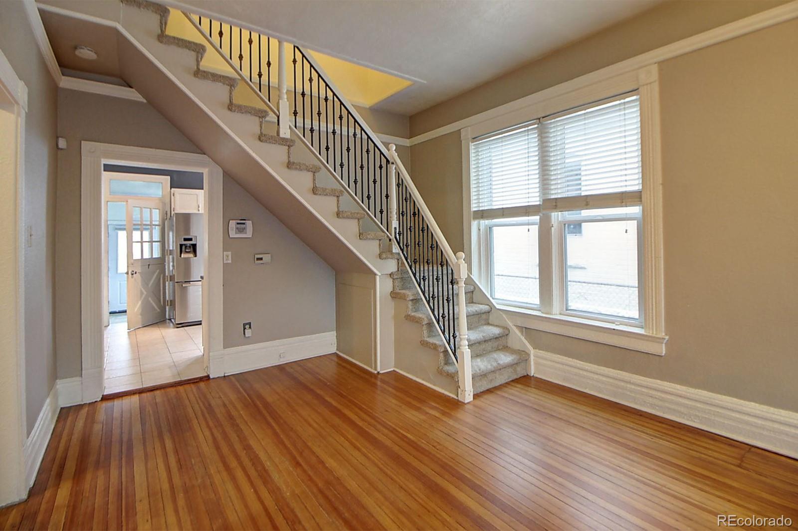 328 Inca Street Denver, CO 80223 - Photo 7 of 35 a view of entryway with wooden floor