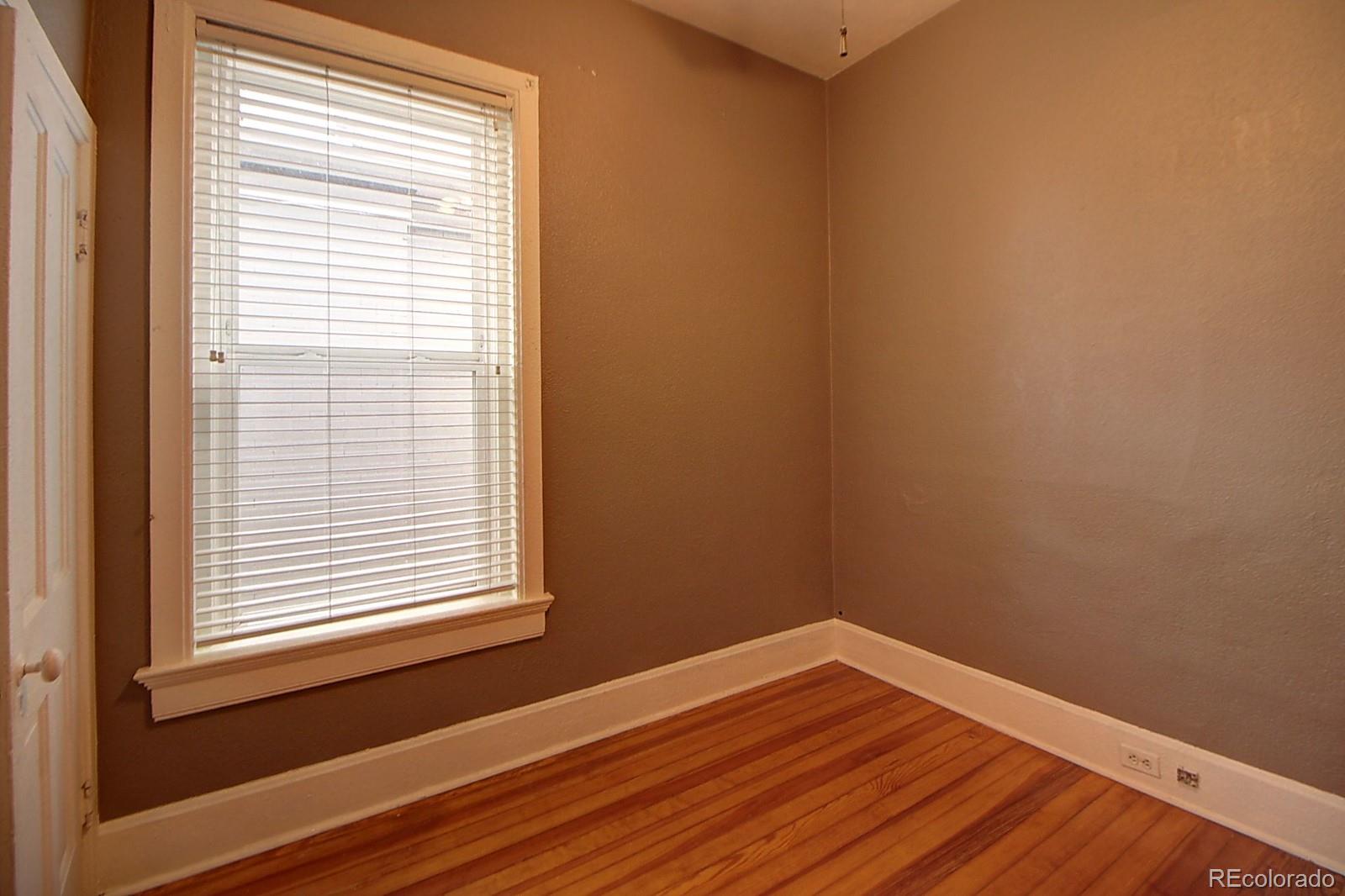 328 Inca Street Denver, CO 80223 - Photo 8 of 35 a view of a small space with wooden floor and a window