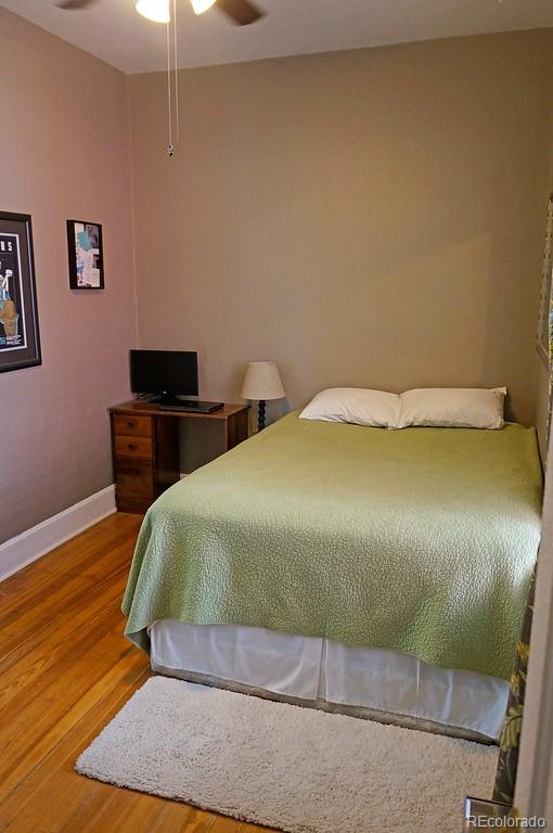 328 Inca Street Denver, CO 80223 - Photo 9 of 35 a bedroom with a bed and wooden floor
