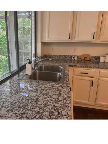a kitchen with a sink and cabinets