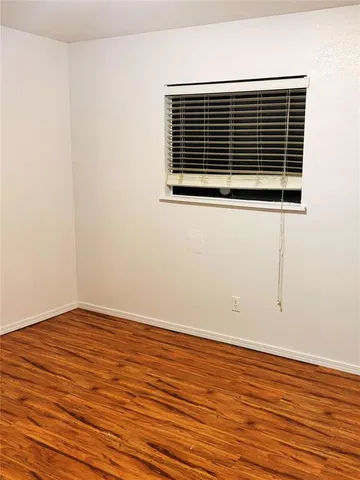 an empty room with wooden floor