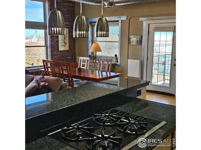 a hallway with wooden floor chandelier and livingroom
