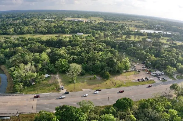 an aerial view of a houses with yard