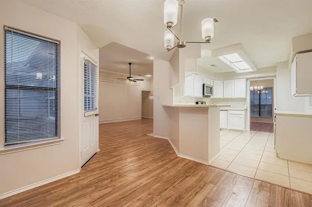 a kitchen with stainless steel appliances kitchen island granite countertop a refrigerator and a sink