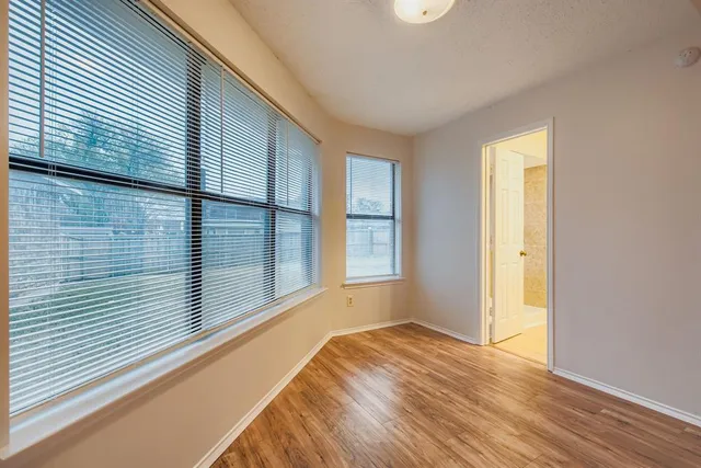a view of a room with wooden floor and windows