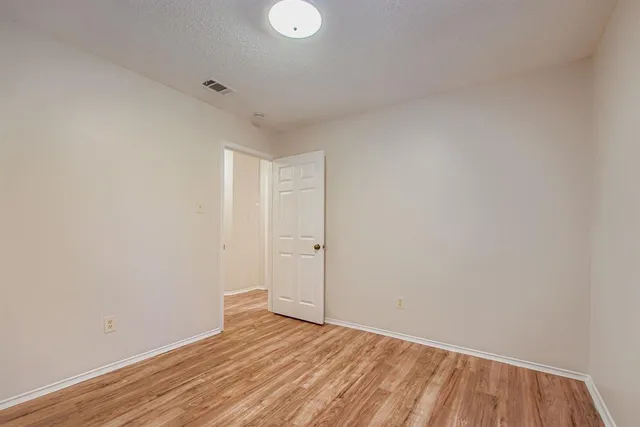 a view of an empty room and wooden floor
