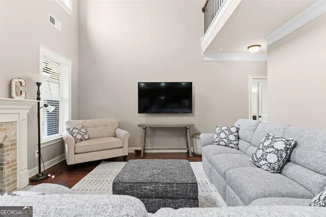 a living room with furniture and kitchen view
