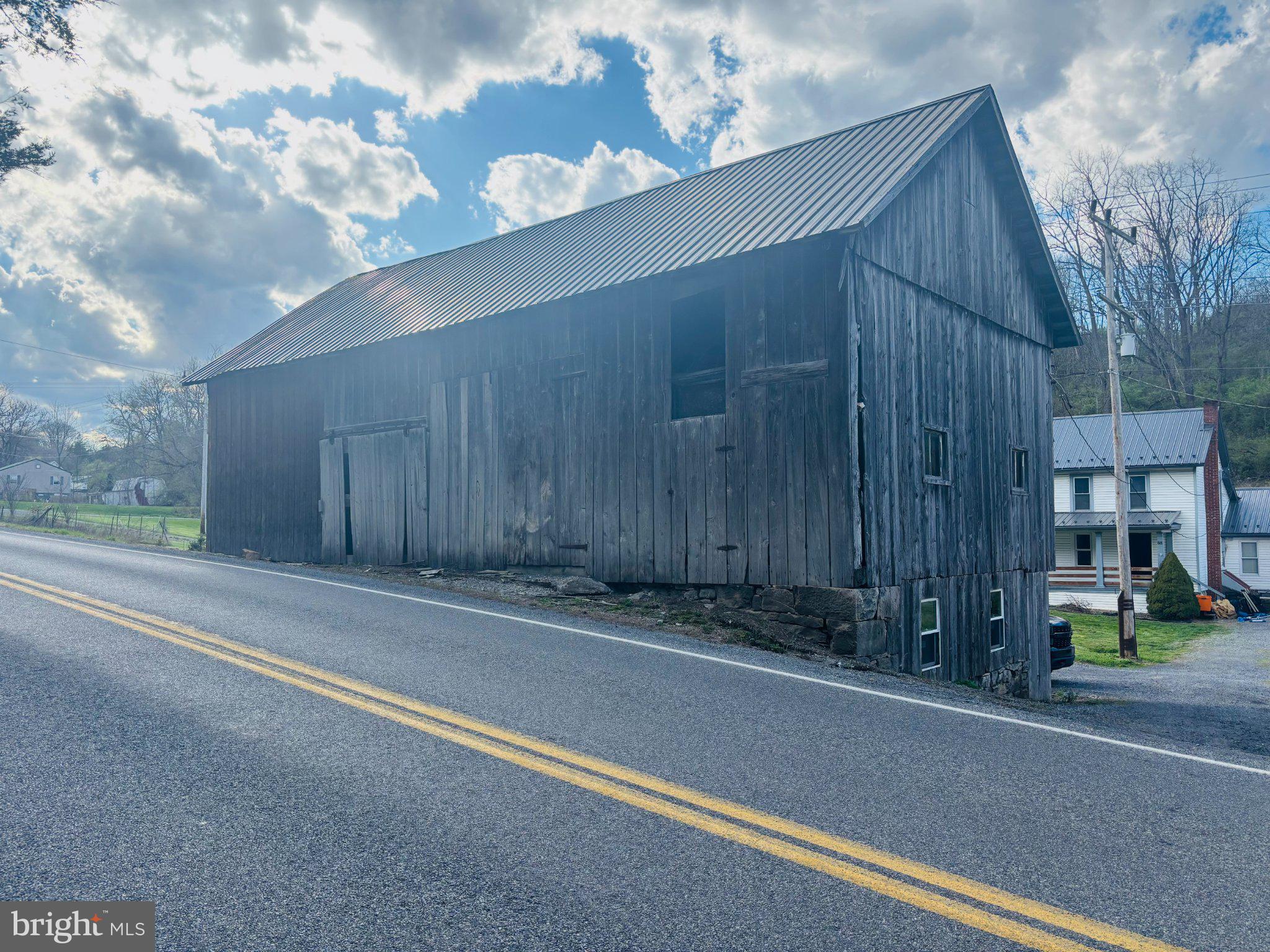 153 Buffalo Run Road Bellefonte, PA 16823 - Photo 3 of 7 Rustic barn against a scenic sky.