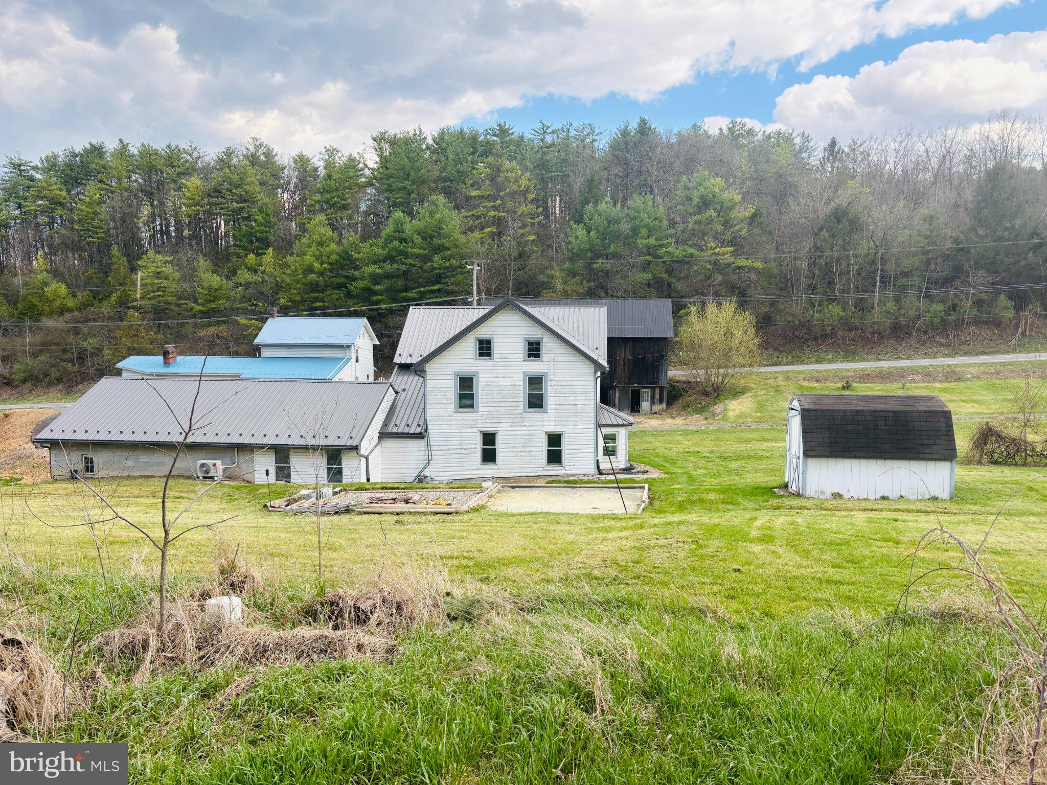 153 Buffalo Run Road Bellefonte, PA 16823 - Photo 6 of 7 Charming farmhouse amid lush greenery.