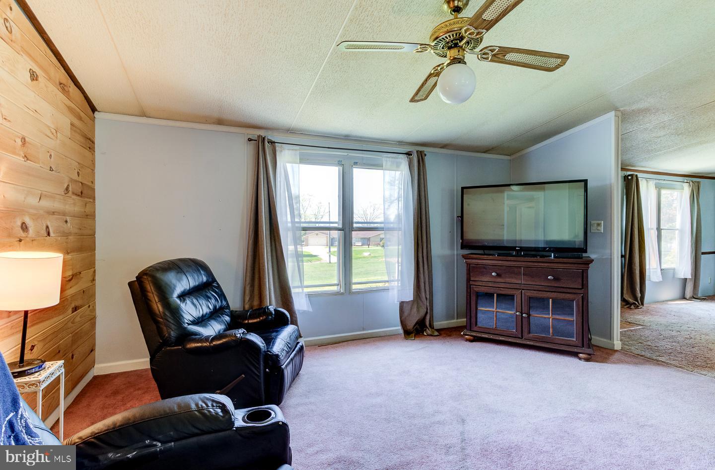 936 Newark Road Avondale, PA 19311 - Photo 11 of 38 a living room with furniture and a flat screen tv