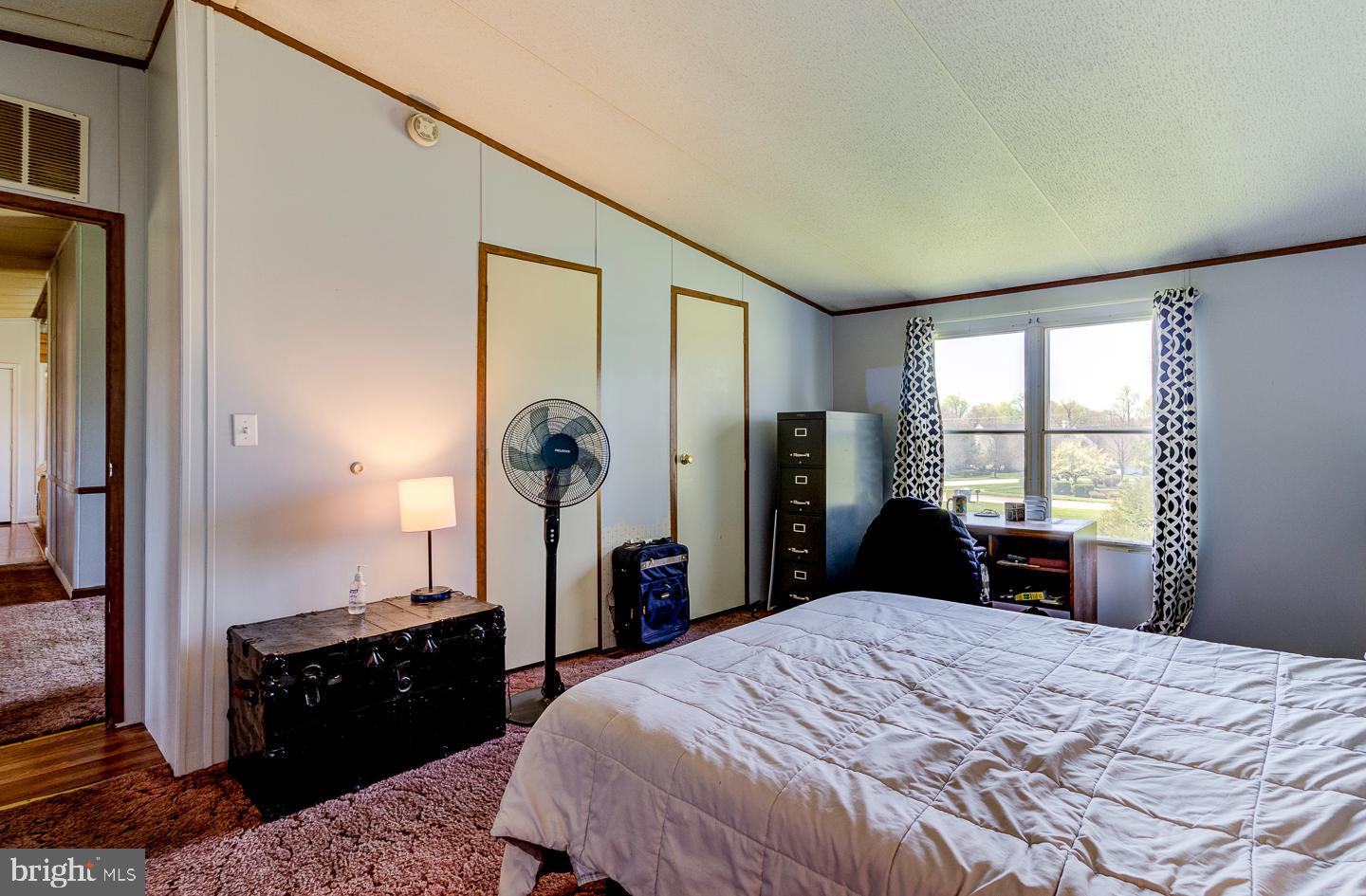 936 Newark Road Avondale, PA 19311 - Photo 13 of 38 a bedroom with a bed and wooden floor