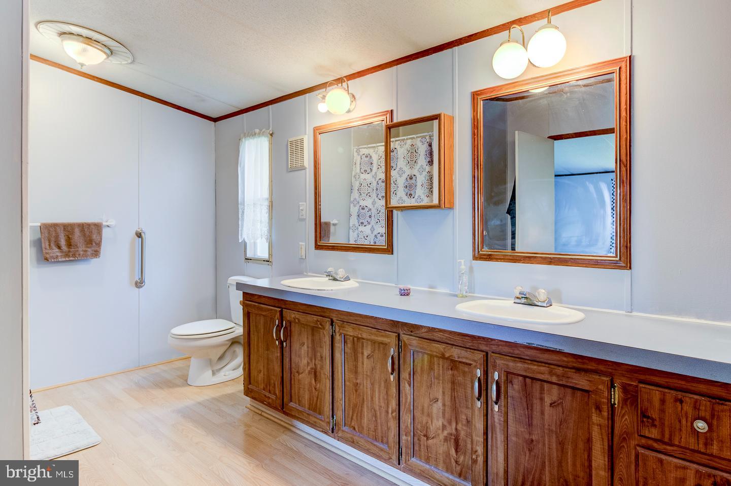 936 Newark Road Avondale, PA 19311 - Photo 16 of 38 a bathroom with a toilet sink and mirror