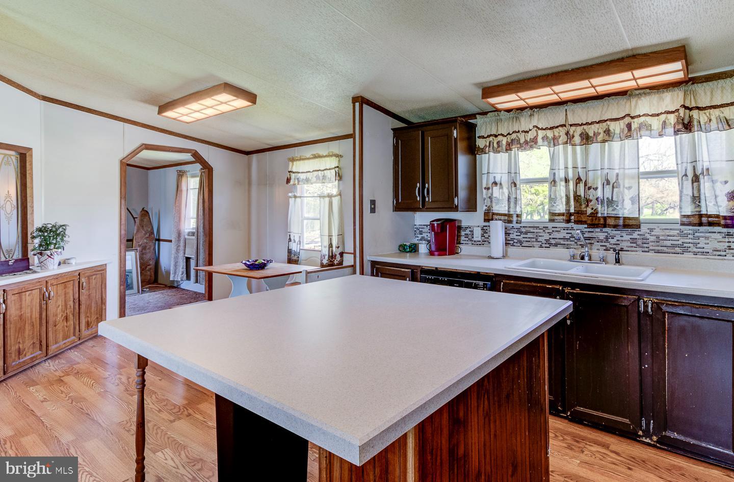 936 Newark Road Avondale, PA 19311 - Photo 2 of 38 a kitchen with a stove a sink a counter space and a dining table