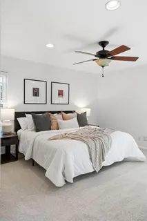 a bedroom with a bed and a painting on the wall