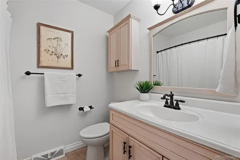 a living room with furniture and a painting on the wall