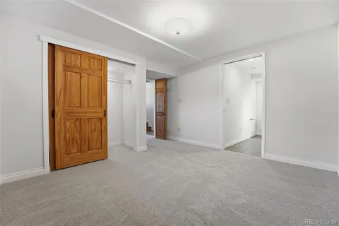 a backyard of a house with barbeque oven table and chairs