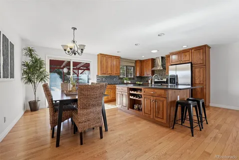a view of a dining room with furniture kitchen and wooden floor