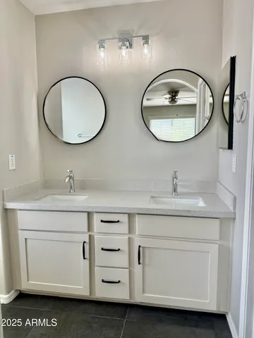 a bathroom with a double vanity sink and a mirror