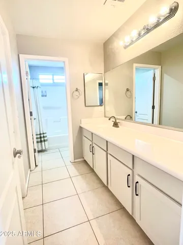 a spacious bathroom with a mirror sink and vanity