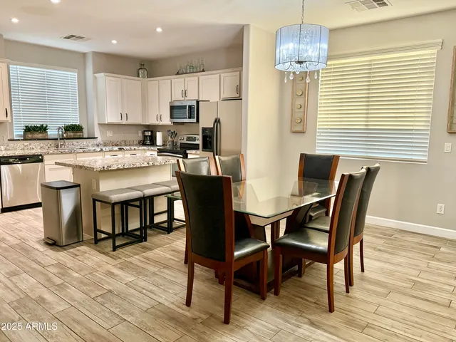 a view of a dining room with furniture wooden floor and chandelier