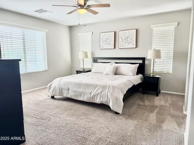 a bedroom with a bed and ceiling fan