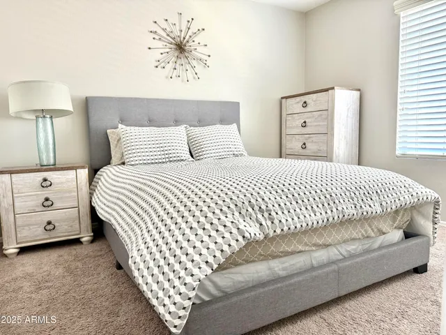 a bedroom with a bed and a night stand