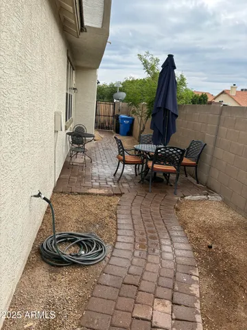 a view of outdoor kitchen with a fireplace