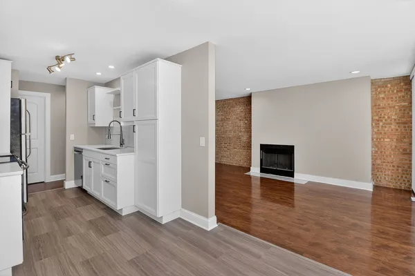 a kitchen with stainless steel appliances a refrigerator sink and cabinets