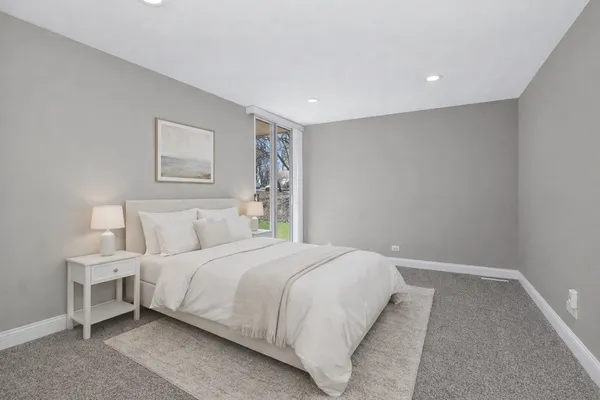 a bedroom with a bed and a painting