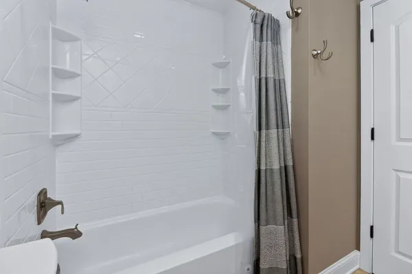 a bathroom with a bathtub and a shower