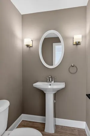 a bathroom with a sink toilet and mirror