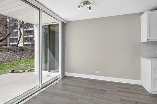 a view of a room with wooden floor and a balcony view