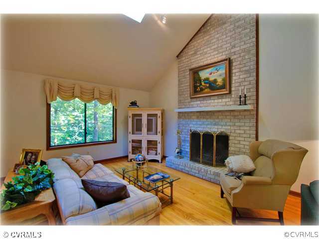3181 East Brigstock Road Midlothian, VA 23113 - Photo 2 of 16 a living room with furniture and a fireplace