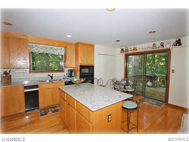3181 East Brigstock Road Midlothian, VA 23113 - Photo 5 of 16 a kitchen with a stove a refrigerator and a coffee table