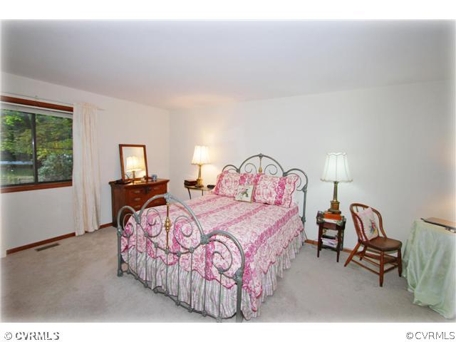 3181 East Brigstock Road Midlothian, VA 23113 - Photo 7 of 16 a bedroom with a bed a table and chair